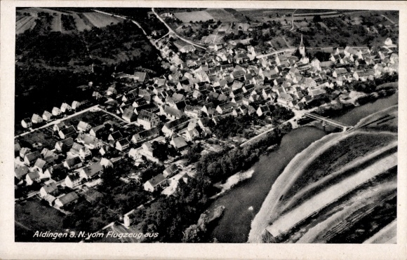 Postcard Aldingen in Württemberg, aerial view of residential buildings, river, bridge