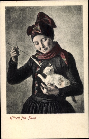 Postcard Woman in Danish costume plays with a kitten
