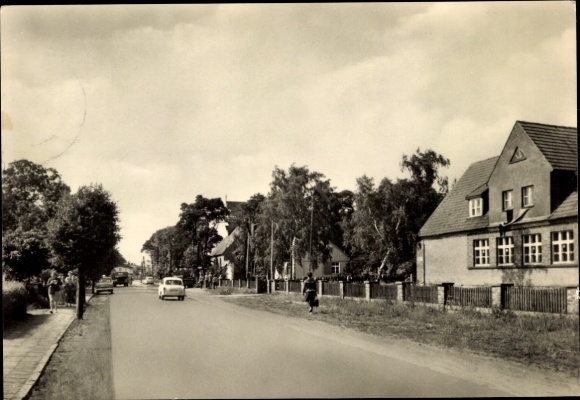 Postcard Ostseebad Carlshagen Karlshagen on Usedom, street with cars, trees, residential buildings on the right...