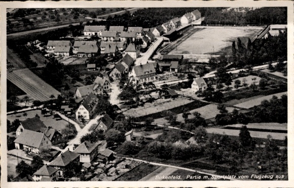 Postcard Birkenfeld an der Nahe, aerial view of sports field, residential buildings, fields