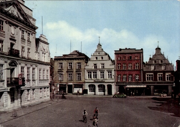 Postcard Güstrow in Mecklenburg, city view, house facades, cyclists, blue sky, crossroads...