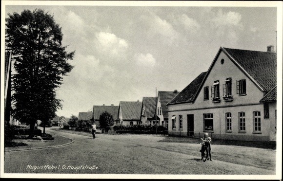 Postcard Augustfehn Apen in Oldenburg Ammerland, main street, cyclists