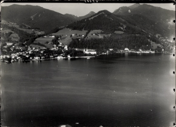 Postcard Tegernsee in Upper Bavaria, view of the wooded shore to the right, with the mountains behind.