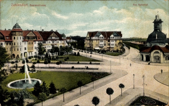 Postcard Berlin Zehlendorf, street section at the train station, green areas, fountain, shops