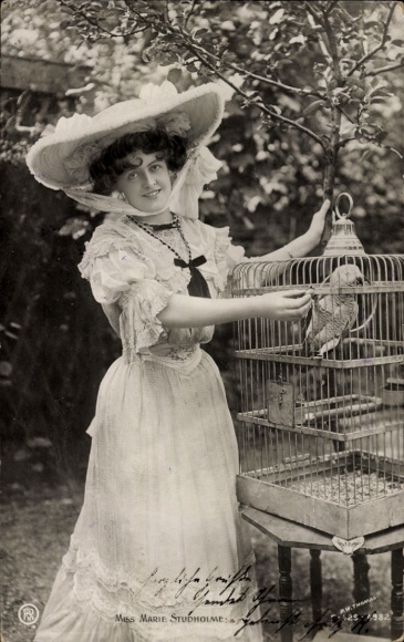 Postcard actress Marie Studholme with parrot in birdcage