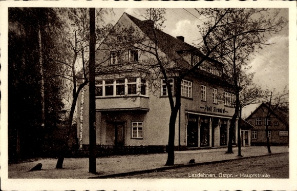 Postcard Krasnosnamensk Lasdehnen East Prussia, Main Street, Adolf Stenokat Commercial Building