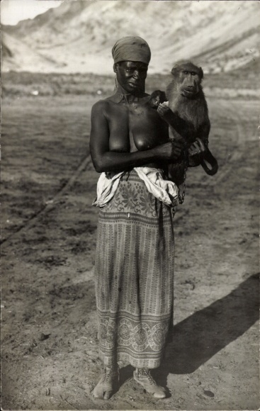 Postcard African woman with a monkey, portrait