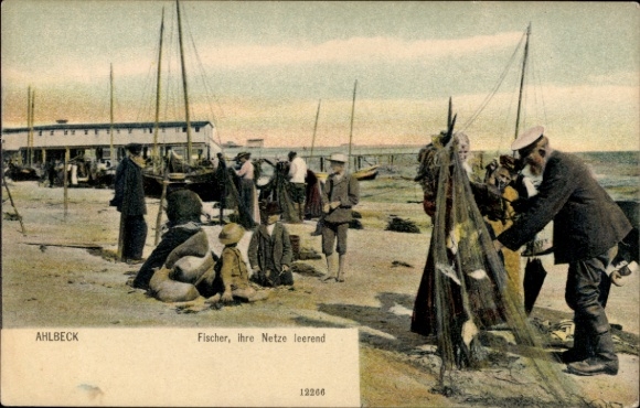 Picture of the Baltic Sea resort of Ahlbeck on Usedom, fishermen on the beach, emptying nets, boats, houses in the background