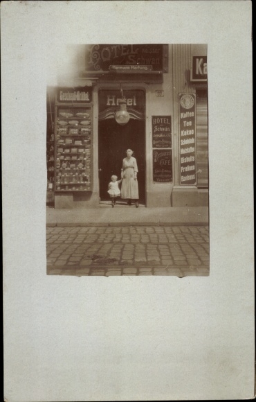 Photo Postcard Hotel Weißer Schwan, woman with child in front of the entrance