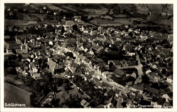 Postcard Schlüchtern in Hesse, aerial view of many houses, landscape, churches