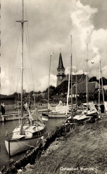 Postcard Ostseebad Wustrow Fischland, harbor with sailboats, church in the background, clouds in the sky