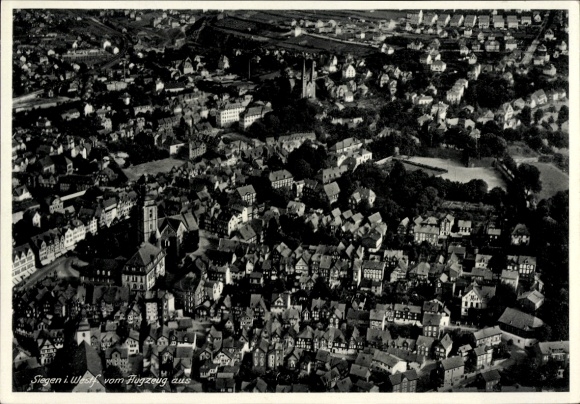 Postcard Siegen in Westphalia, aerial view of many houses, green surroundings, church visible