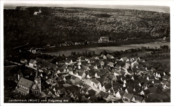 Postcard Laudenbach am Main Lower Franconia, aerial view of many roofs, church, forest in the background
