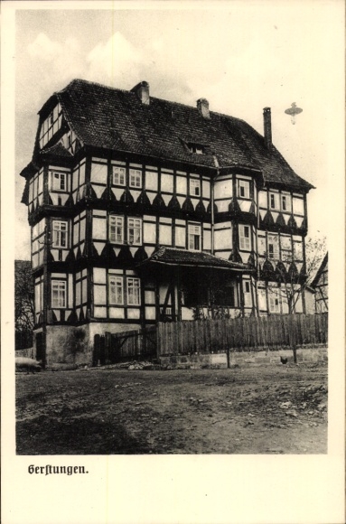 Postcard Gerstungen in Thuringia, historic half-timbered house, black and white, sky with airplane