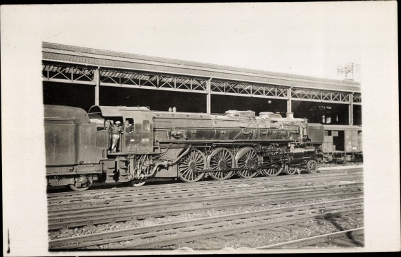 Photo French railway in a station, steam locomotive