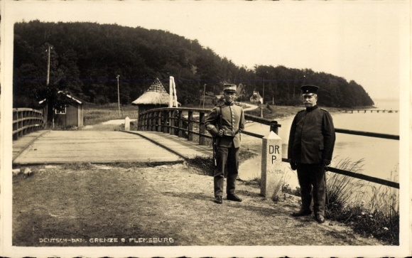 PC Flensburg in Schleswig Holstein, two men in uniform, bridge, boundary stone, river