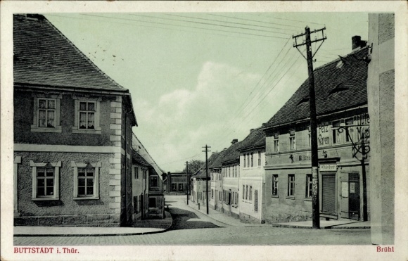 Postcard Buttstädt in Thuringia, street in houses, power poles, clear skies