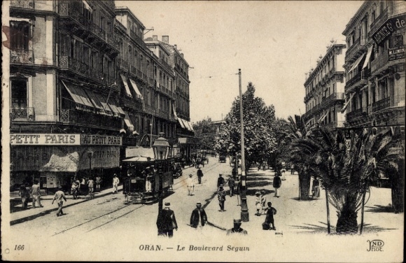 Ak Oran Algerien, Boulevard Seguin, Straßenbahn, Geschäfte, Petit Paris, Palmen