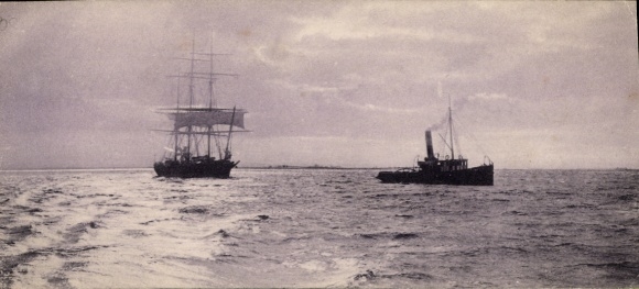Postcard tug tows two-masted ship