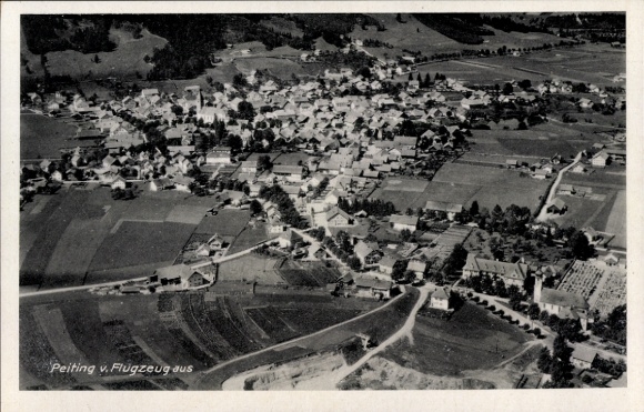 Postcard Peiting in Upper Bavaria, aerial view, numerous buildings, green meadows, mountains in the background
