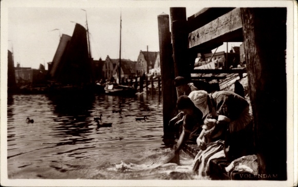 Postcard Dutch women wash laundry in the canal