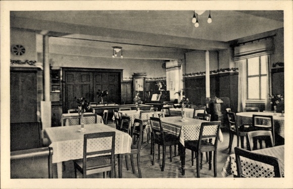Postcard Ebersdorf in Thuringia, guest room with tables and chairs, flowers on the table, simple furnishings