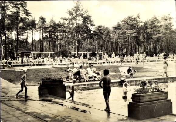 Postcard Niesky in Upper Lusatia, swimming pool with many visitors, surrounded by trees, parasols