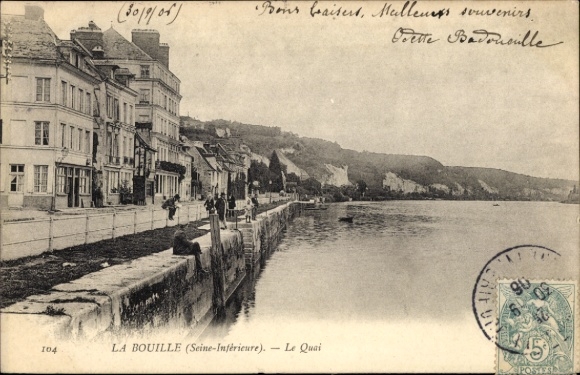 Postcard La Bouille Seine Maritime, waterfront promenade with buildings, water, trees, steep cliffs