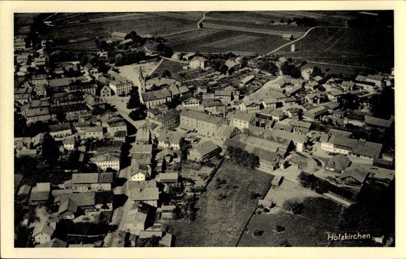 Postcard Holzkirchen in Upper Bavaria, aerial view of residential buildings, church, green areas