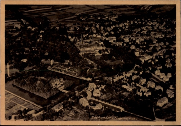 Postcard Bad Pyrmont in Lower Saxony, aerial view of many houses, green landscape