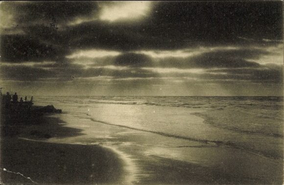 Postcard North Sea resort Juist in East Frisia, beach view, waves, cloudy sky, silhouettes of men
