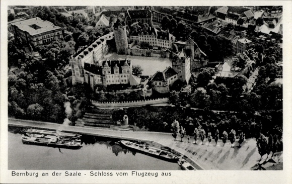 Postcard Bernburg an der Saale, aerial view of Bernburg Castle, Saale River, ships, trees