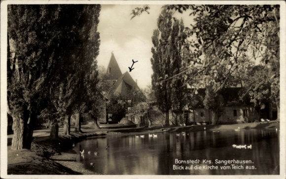 Postcard Bornstedt in Saxony-Anhalt, church seen from the pond