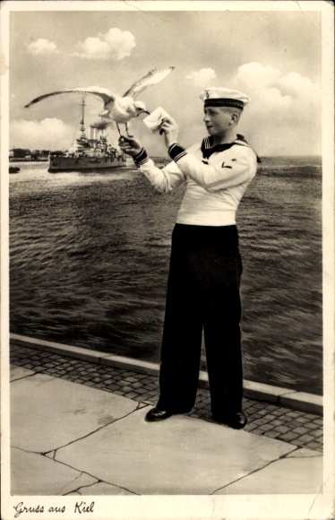 Postcard Kiel, sailor hands a letter to a seagull, warship, navy
