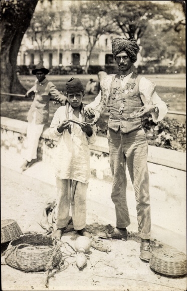 Photo Postcard man and boy with snakes, snake charmer