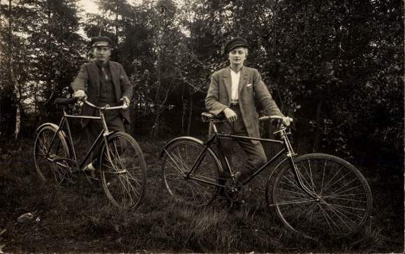 Photo Postcard portrait of two men with their bicycles