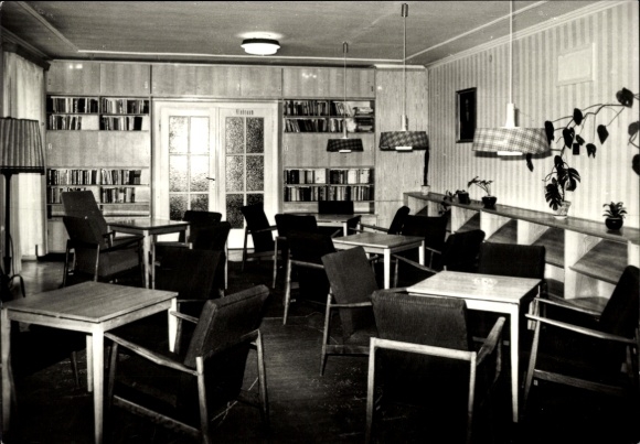 Postcard Friedrichroda in the Thuringian Forest, interior view of a library, wooden shelves, tables, chairs, plants