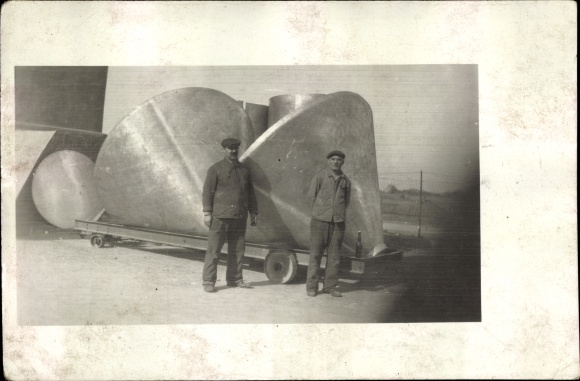 Photo Postcard Two workers in front of large metal parts