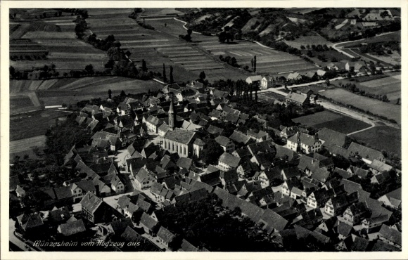 Postcard Münzesheim Kraichtal in Baden, aerial view, old houses, church, rural surroundings, meadows,