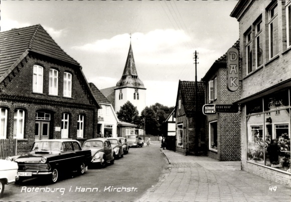 Rotenburg PC in Hann. Rotenburg an der Wümme, street with houses, church in the background, vintage...