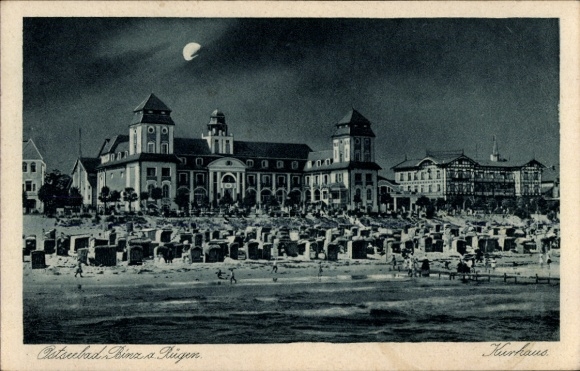 Postcard Baltic Sea resort Prora Binz on Rügen, spa house, beach chairs, people on the beach, evening atmosphere, moon