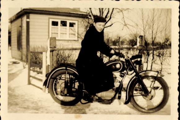 Photo woman in coat on a motorcycle, winter 1952, snow