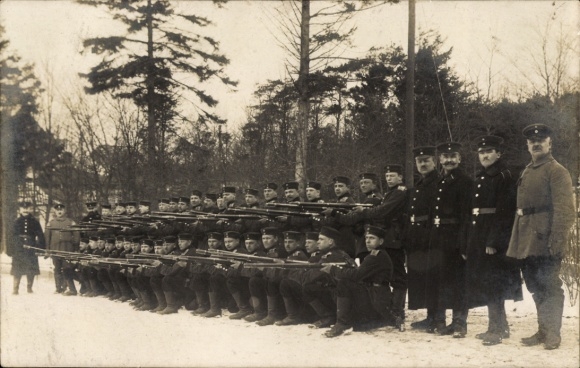 Photo Postcard Imperial Infantry posing in winter with weapon at the ready in Glücksburg