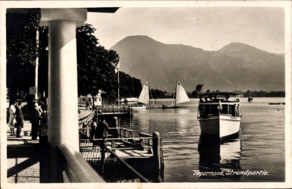 Postcard Tegernsee in Upper Bavaria, beautiful lake landscape, boats, mountains, beach promenade