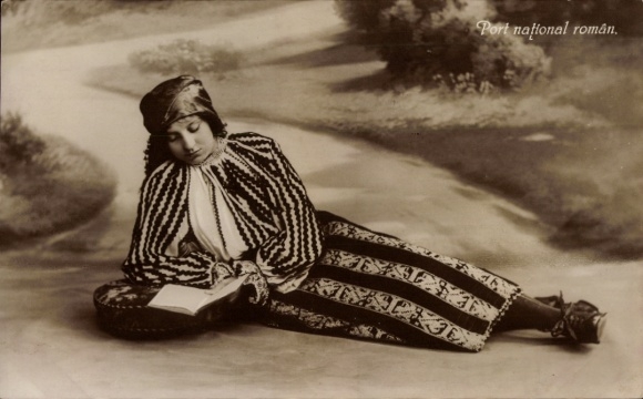 Postcard Woman in Romanian folk costume reading