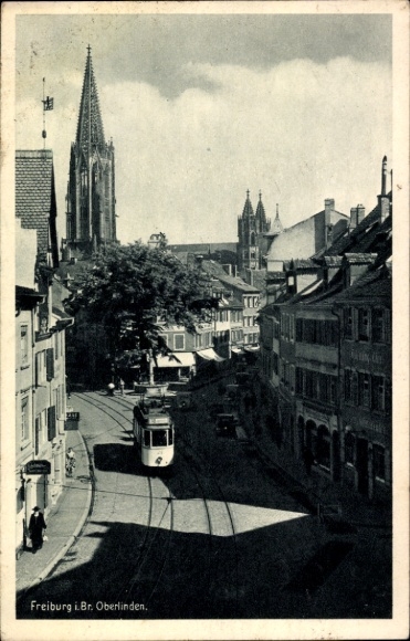 Ak Freiburg im Breisgau, Stadtansicht mit Straßenbahn, Oberlinden,  Kirche im Hintergrund