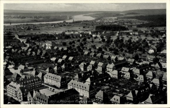 Ak Weil am Rhein, Luftaufnahme von  Fluss sichtbar, Stadtansicht mit Häusern