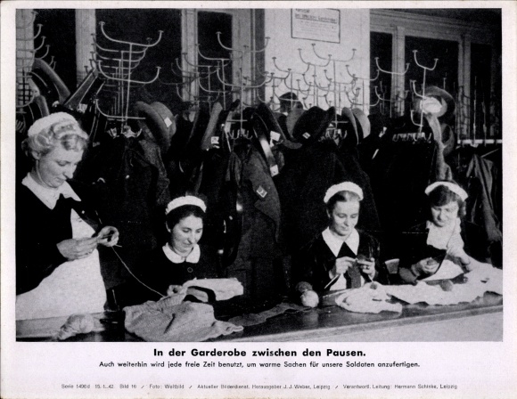 Photo In the cloakroom between breaks, women make warm clothes for soldiers, WWII