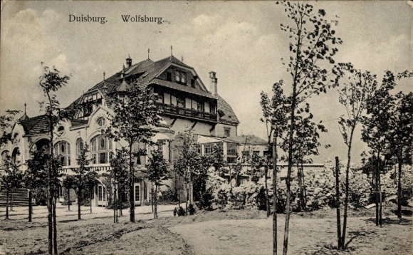 Postcard Wolfsburg in Lower Saxony, historic building, trees in the foreground, view