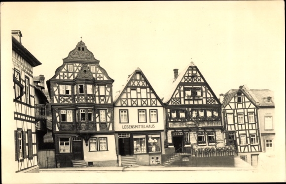 Photo Postcard Idstein in Taunus Hesse, old houses on Graf Adolf Platz, grocery store